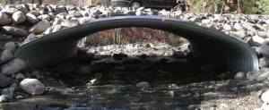 Steel box culvert stream crossing structure installed over rocky creek