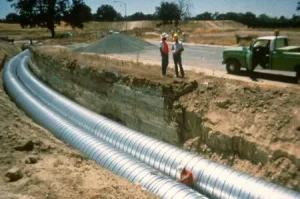 Corrugated steel storm sewer pipe installed in a deep trench for municipal drainage