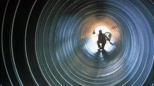 Worker inside a corrugated steel storm sewer pipe during installation
