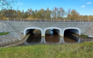 Multi-cell structural plate railway bridge spanning the Łada River after rehabilitation.