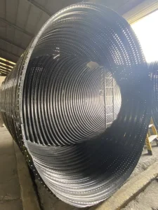 Polymer-coated corrugated steel pipe prepared for installation as part of a commercial stormwater retention system.