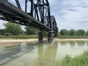 Active Pierre & Eastern Railroad bridge crossing during bridge pier rehabilitation in South Dakota.