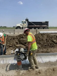Slotted drain pipe installation along the Interstate 35 roadway improvement project in Iowa.