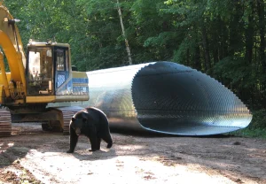 Corrugated steel structural plate bridge supporting wildlife-friendly infrastructure