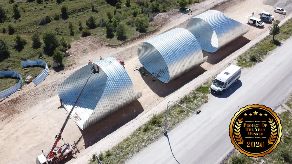 Assembly of large corrugated steel structure sections for a railway underpass project in Cankiri, Türkiye.