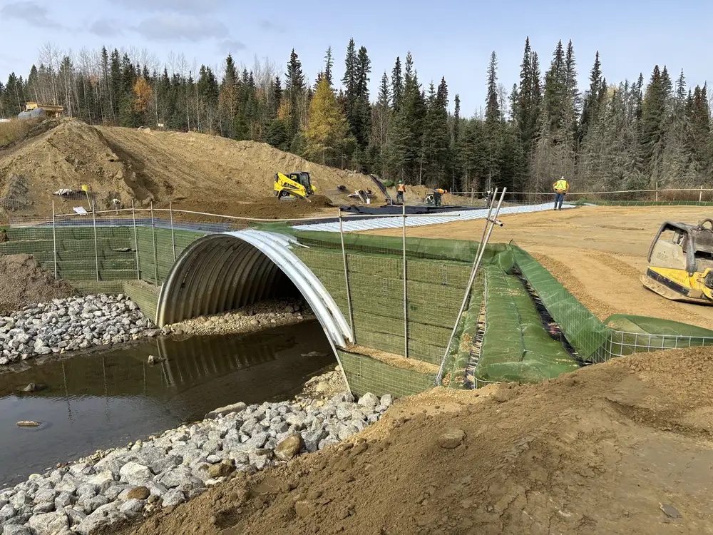 Construction crews installing the Super-Cor arch during the Emerson Creek culvert replacement.