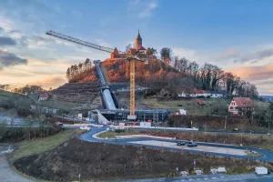 The completed incline lift enclosure climbing the steep hillside beneath Leuchtenburg Castle in Germany.