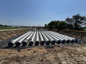 Crews installing 42-inch corrugated steel pipe for the Oak-Land Middle School stormwater retention system.