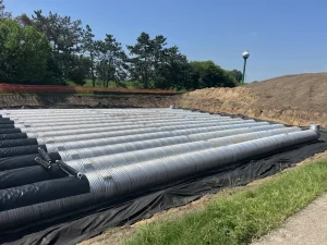 Perforated corrugated steel pipe installed underground during construction at Oak-Land Middle School in Minnesota.