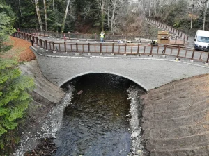 DJI_0530_resized Aerial view of the completed Padden Creek crossing showing the Interurban Trail, steel arch, and restored stream corridor.