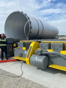 Large corrugated steel pipe section being made on site using a mobile mill