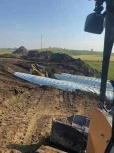 TrueNorth Steel_Oliver County ND Pipe Replacement_CSP(1)_resized 96-inch galvanized corrugated steel pipe sections positioned for installation beneath an Oliver County road.