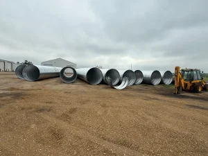 TrueNorth Steel_Oliver County ND Pipe Replacement_CSP(7)_resized Large-diameter galvanized corrugated steel pipe sections staged for the Oliver County culvert replacement.